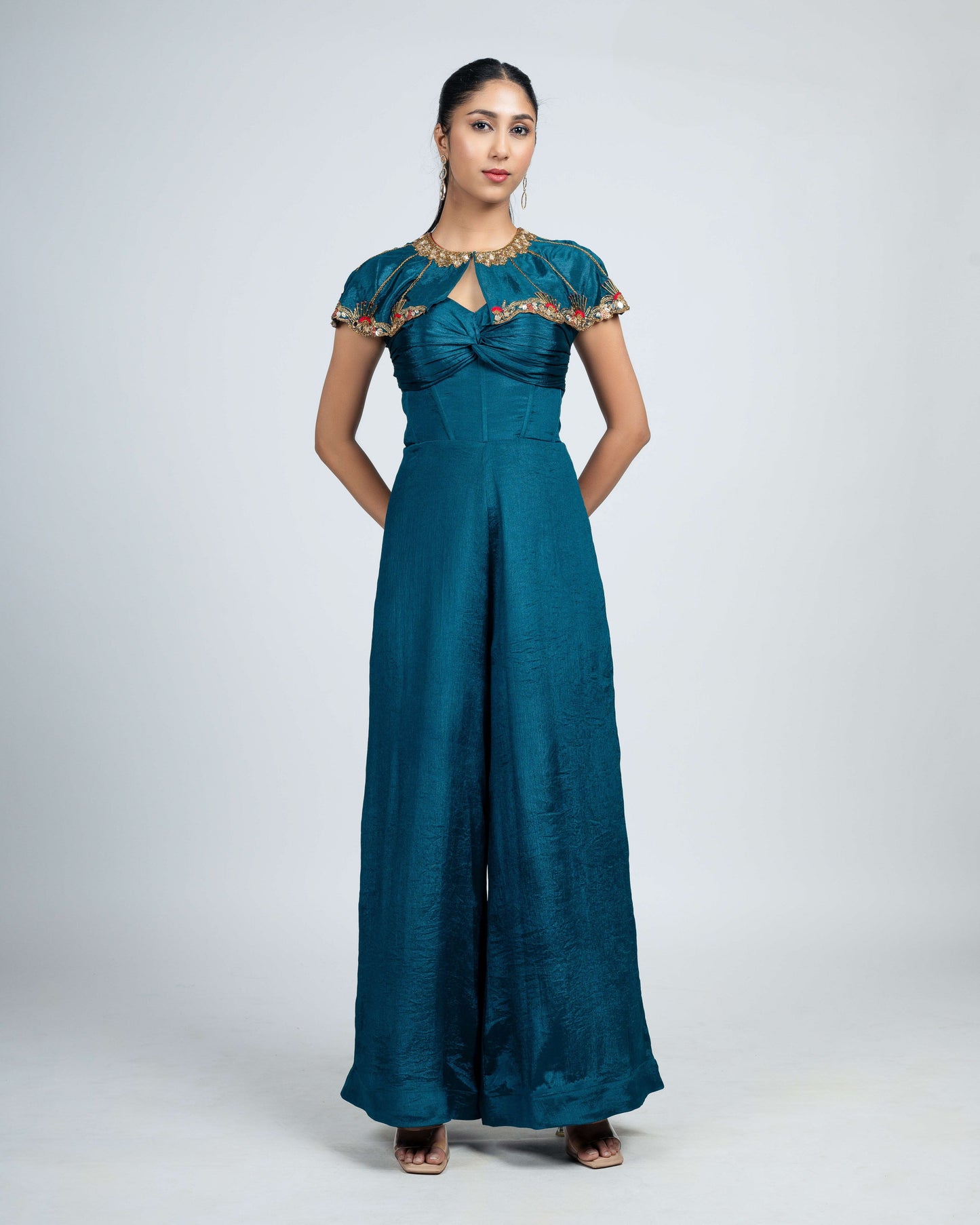 Pleated corset jumpsuit with shoulder cape