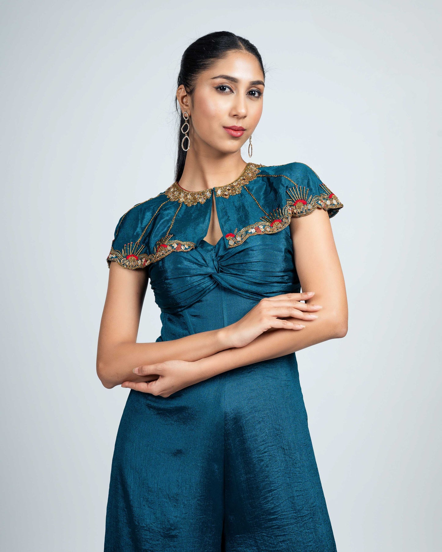 Pleated corset jumpsuit with shoulder cape